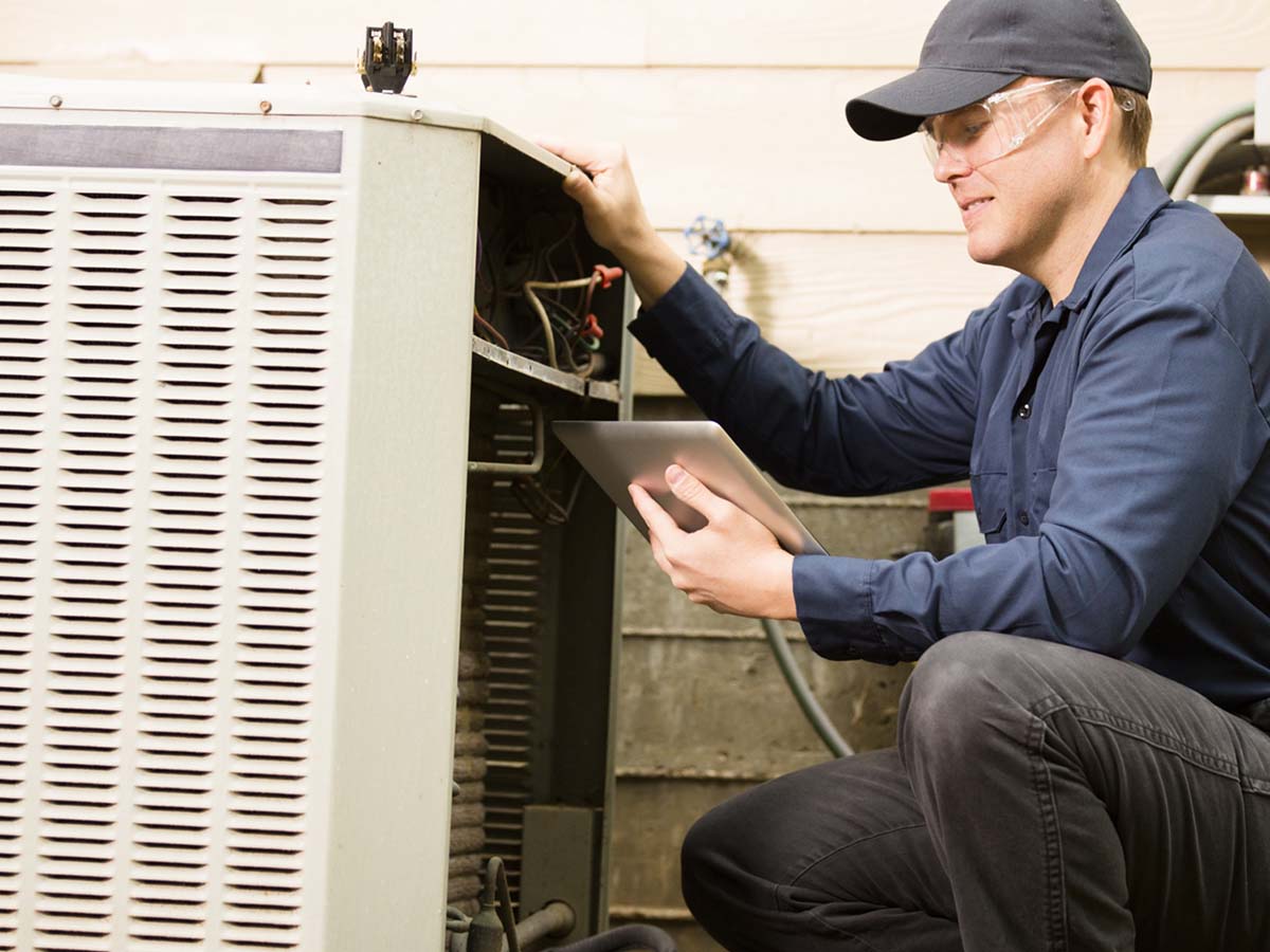 An image of a professional fixing a residential HVAC.