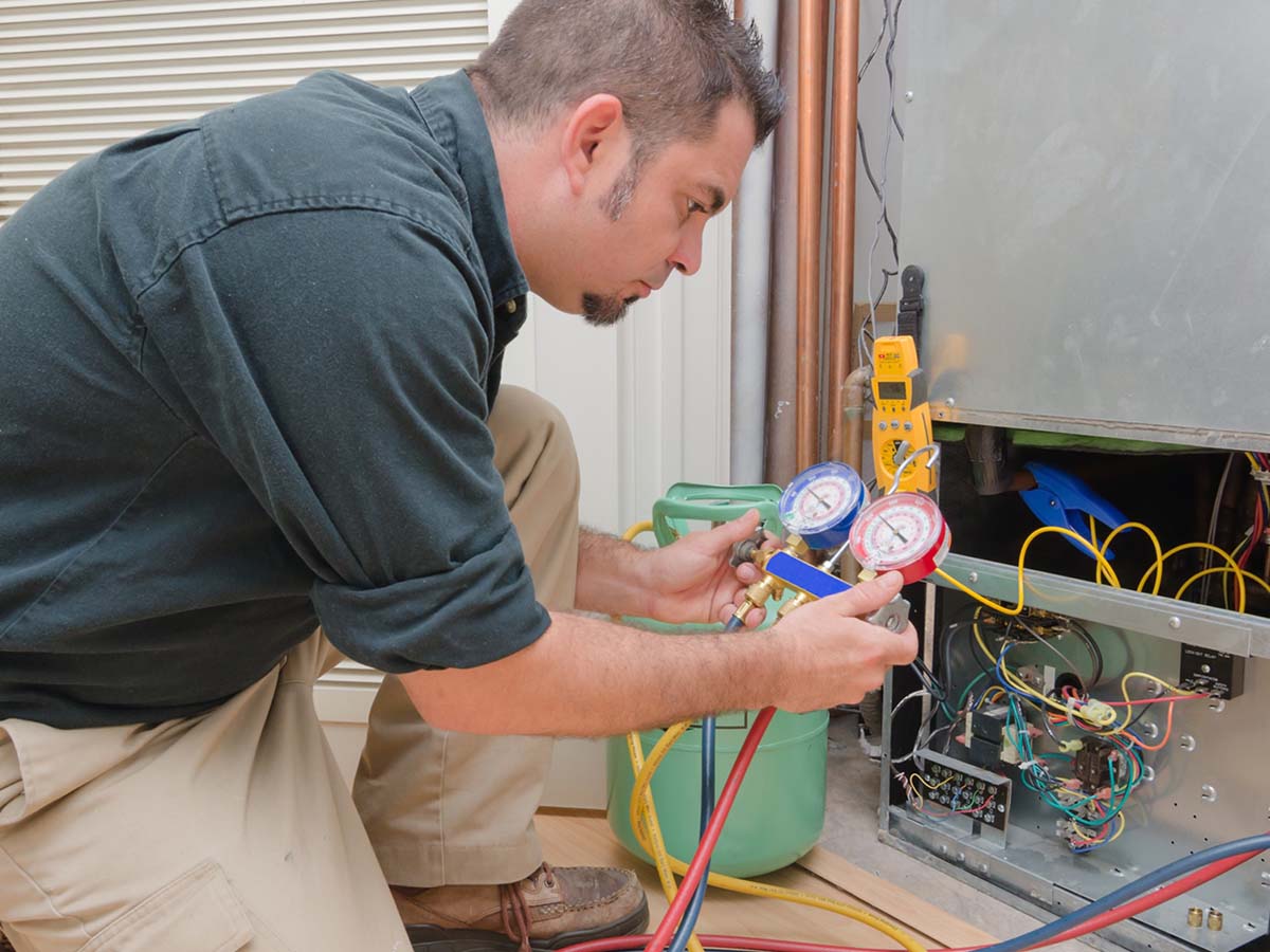 an image of a technician checking an HVAC unit.