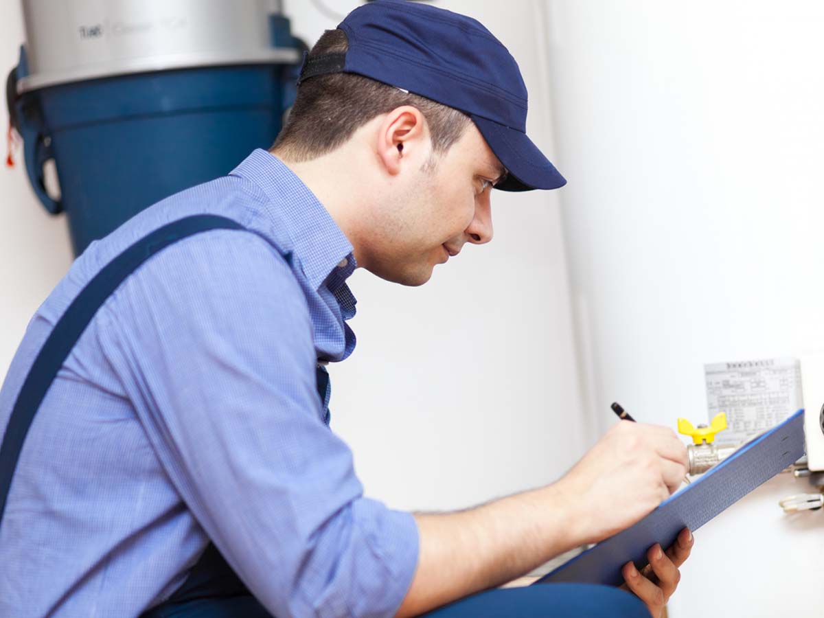 a repairman inspecting a water heater